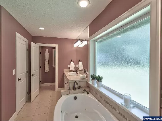 Relaxing Primary Bath Featuring Soaking Tub