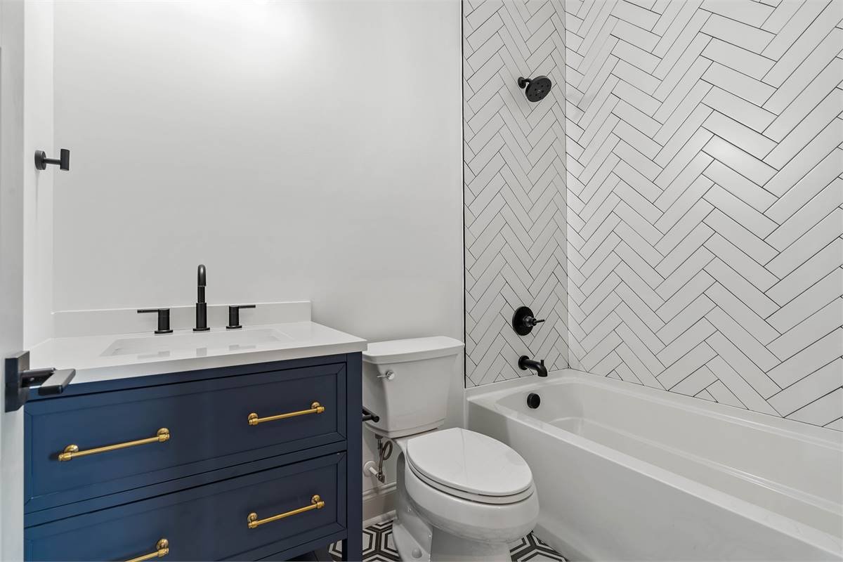 Lovely Secondary Bathroom Featuring Chevron Tile Pattern