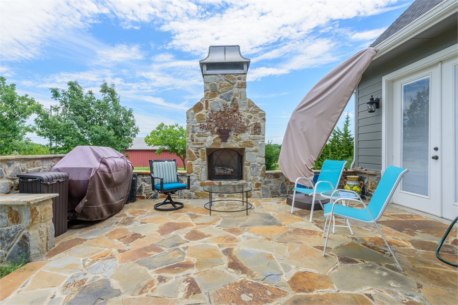 Rear Outdoor Living Featuring Stone Fireplace & Patio image of Vita Encantata House Plan