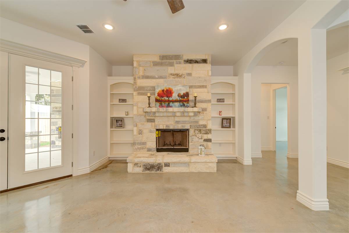 Beautiful Stone Fireplace with Twin Built-Ins image of High Meadow Cabin House Plan