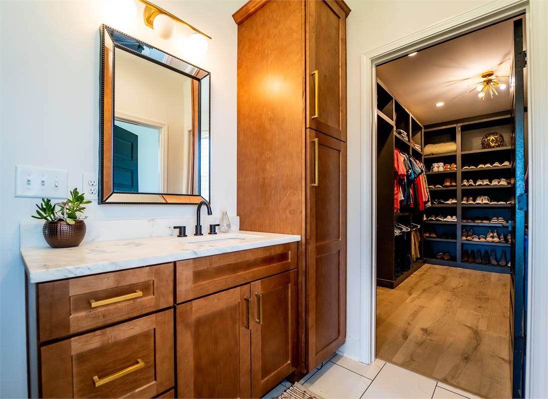 Master Bathroom Vanity View into Oversized Walk-in Closet image of Chelci House Plan