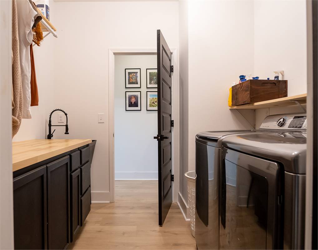 Large Laundry Room Offers Extra Storage Space image of Chelci House Plan