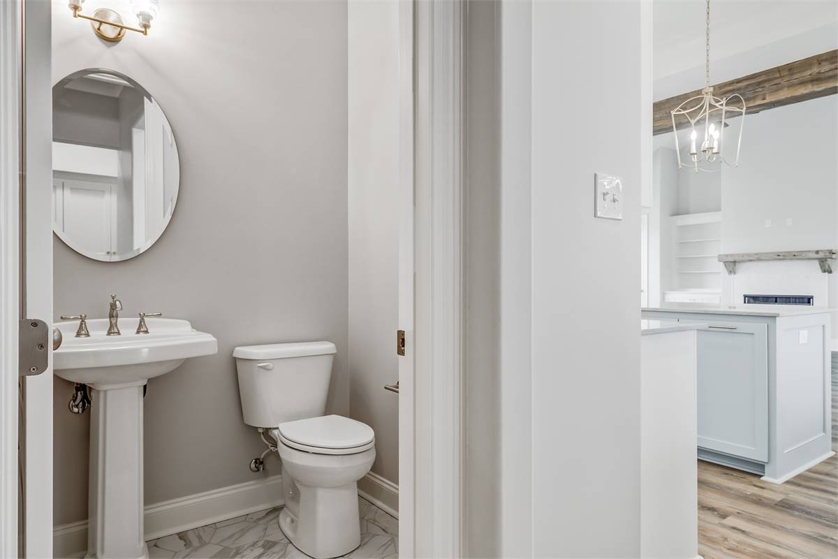 Powder Room Located Between Kitchen and Mudroom Room