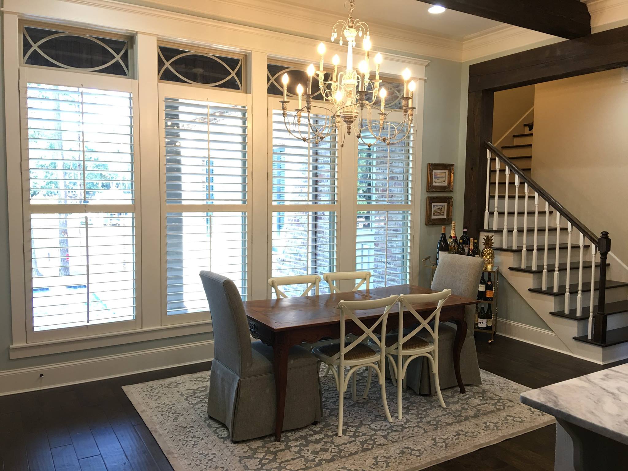 Dining Room Featuring Gorgeous Windows and Open Staircase