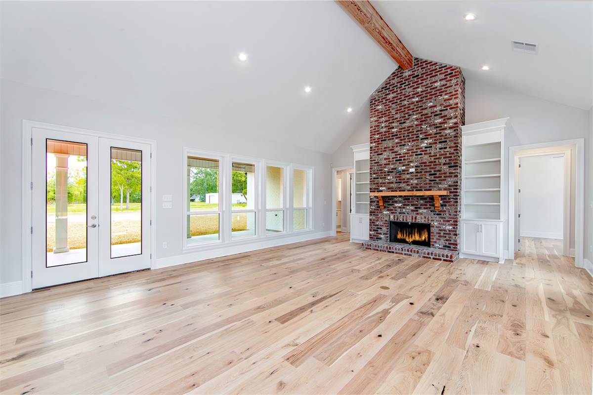 Vaulted Great Room with Wall of Windows and Fireplace image of Wildwood House Plan