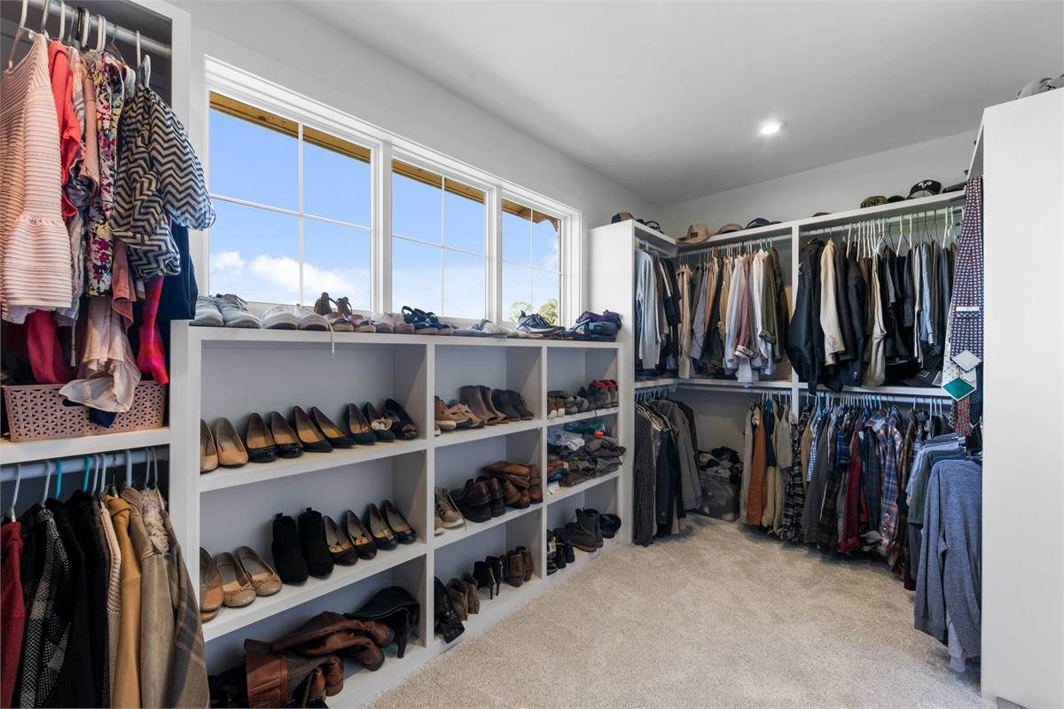 Amazing Master Walk-In Closet with Storage and Lots of Light