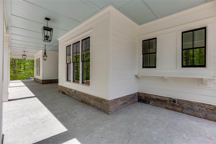 Covered Front Porch with Dining and Guest Room Bump-outs image of Tiverton House Plan