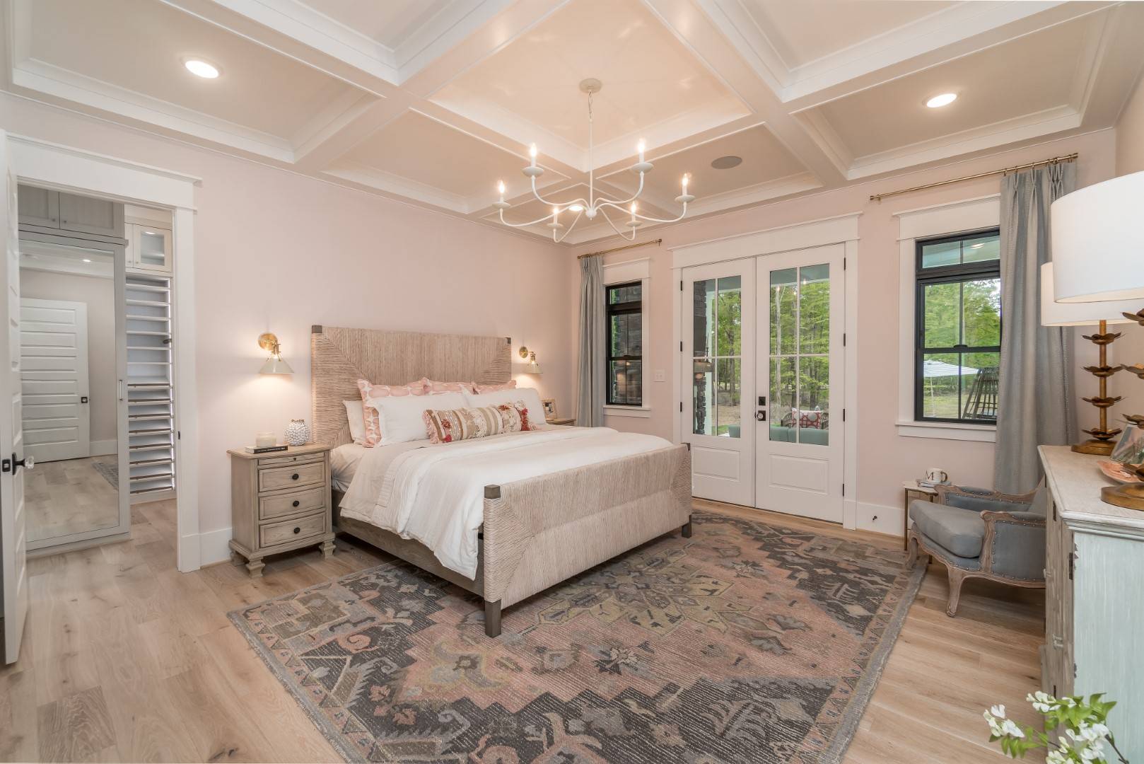 Luxurious Master featuring French Doors and Coffered Ceiling