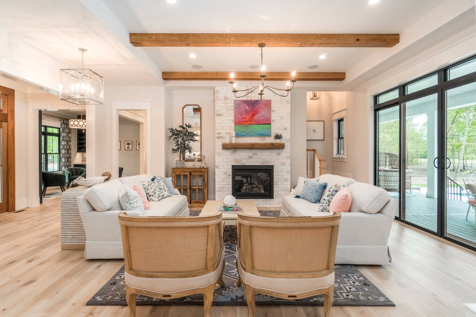 Bright Great Room with Wood Beams, Fireplace and Glass Doors image of Ruth Ann House Plan