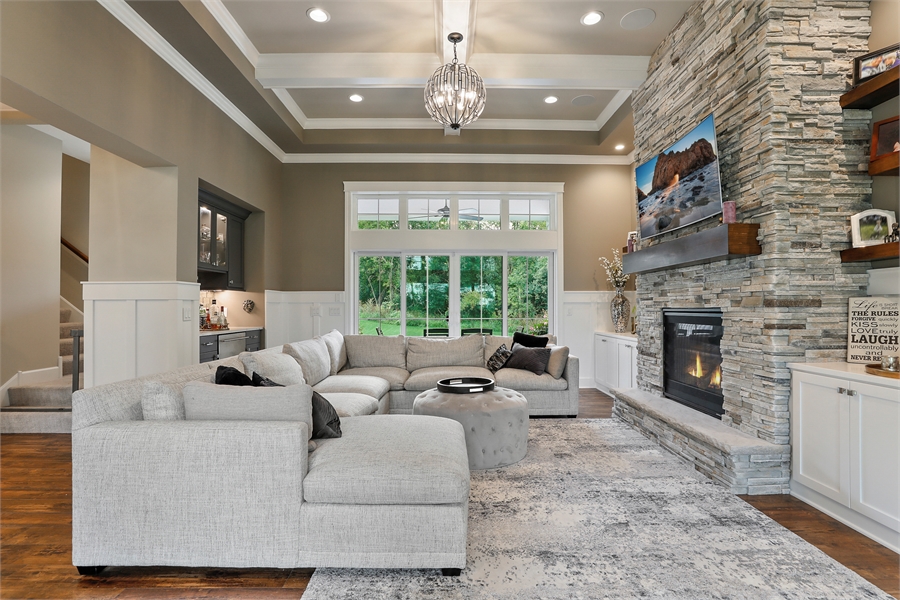 Great Room Featuring Coffered Ceilings and Fireplace