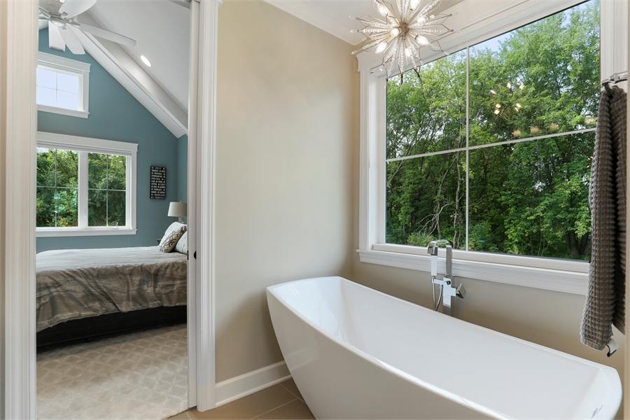 Bright Master Bath Featuring Soaking Tub and Large Windows