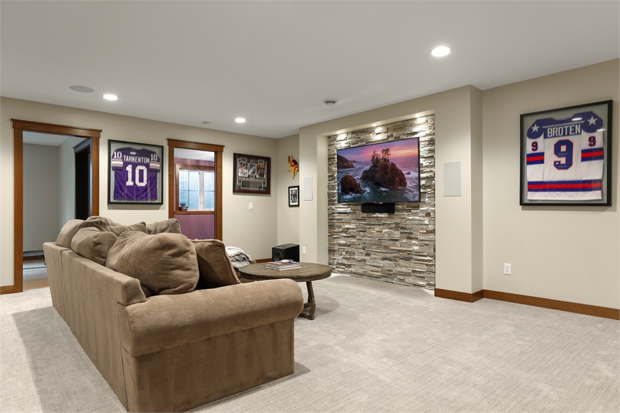 Bountiful Basement with Stacked Stone TV Wall