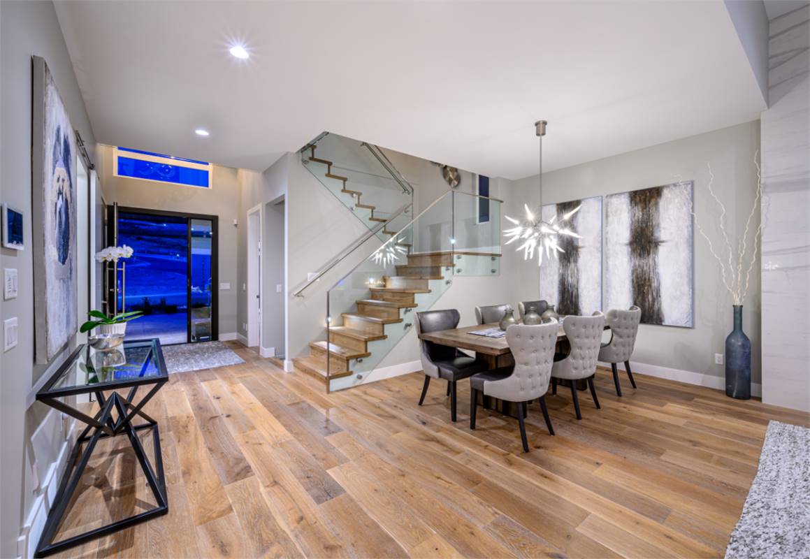 Dining Room Featuring Modern Glass Stair Railing